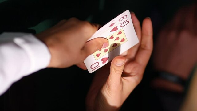 Girl gambler holds five playing cards in hand, on green casino table, poker. success in gambling. girl plays gambling soft focus, vertical orientation video