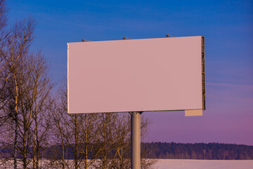billboard along the highway on a winter snow day. Background for design and advertising. 