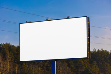Obraz premium Advertising billboard along the road in the city on a winter day. Background for design. 