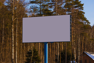 white billboard along the highway on a winter snow day. Background for design and advertising. 
