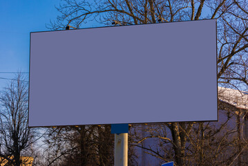 white billboard along the highway on a winter snow day. Background for design and advertising. 