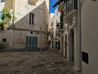 Elevation of buildings in the old city center. Narrow street with tenement houses in the old city. Bari, Italy.