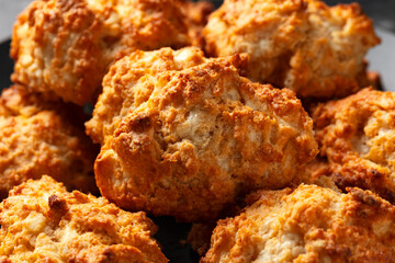 Homemade Cheddar Cheese Biscuits on a black plate