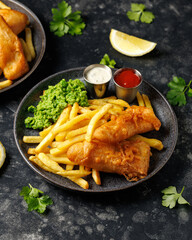 British Fish and chips with mashed peas, tartar and ketchup sauce.