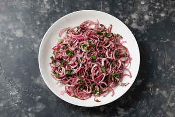 Sumac red onion salad in a white plate