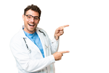 Brazilian doctor man over isolated chroma key background surprised and pointing side