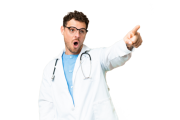 Brazilian doctor man over isolated chroma key background pointing away