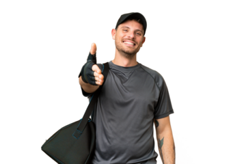 Young sport man with sport bag over isolated chroma key background shaking hands for closing a good deal
