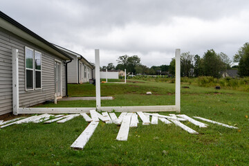 wind destroyed fences in the ground