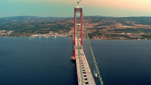 Against a stunning sunset, the ongoing construction of the massive engineering project, the 1915 &Ccedil;anakkale Bridge, stretches between Lapseki and Gelibolu.