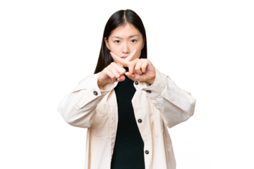 Young Asian woman over isolated chroma key background making stop gesture with her hand to stop an act