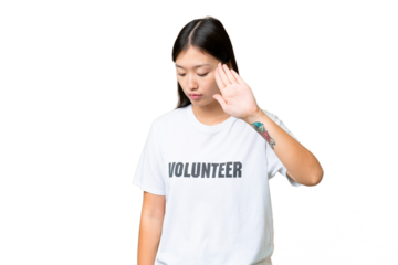 Young volunteer woman over isolated chroma key background making stop gesture and disappointed