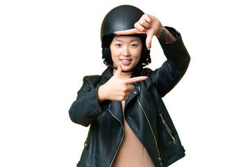 Young Asian woman with a motorcycle helmet over isolated chroma key background focusing face. Framing symbol