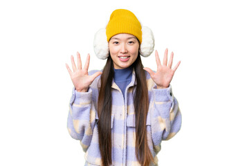Young Asian woman wearing winter muffs over isolated chroma key background counting ten with fingers