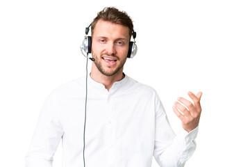 Telemarketer caucasian man working with a headset over isolated chroma key background making guitar...
