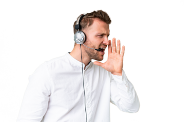 Telemarketer caucasian man working with a headset over isolated chroma key background shouting with mouth wide open to the lateral