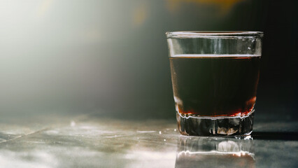 A glass of Iced americano in the kitchen, sunlight through the fog