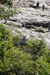 person sliding on a zip line in a forest in the Andes Mountains in southern Chile