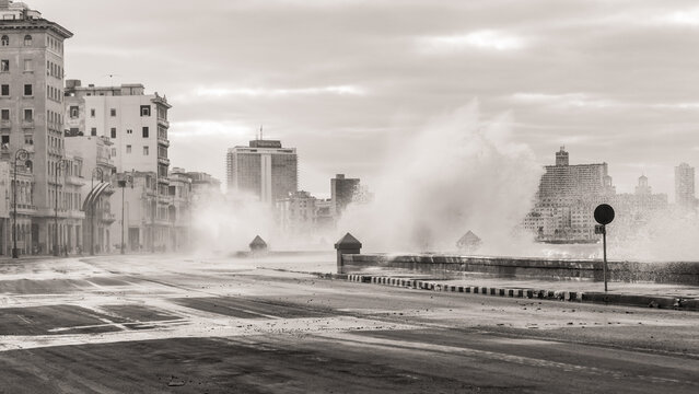 Malecon, Cuba skyline and waves crashing in black and white. 