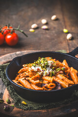 Pasta rigatoni with radicchio, pistachios, ricotta and chili