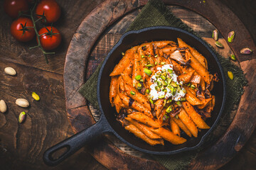 Pasta rigatoni with radicchio, pistachios, ricotta and chili