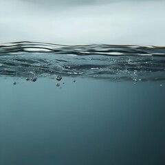 Obraz premium Close-up of water surface with air bubbles rising to the top.