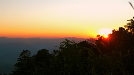 Breathtaking sunrise illuminates sky over serene mountain landscape, casting warm colors across horizon and highlighting natural beauty of wilderness, Tranquility and Nature.