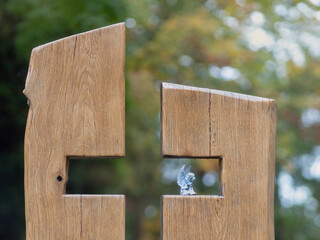 Gestaltetes Holzkreuz aus Eiche und kleiner Engelsfigur, herbstliche Stimmung am Grab