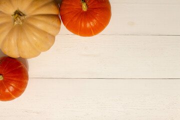 Halloween background with pumpkins. Flat lay. Frame with Halloween figures on white table, top view. Hallowen decorations for greeting and invitation. Happy Helloween concept. Holidays background
