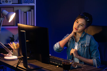 Young beautiful Asian businesswoman taking break with stretching body with ache symptom for relaxing muscle after finishing overworked load report at neon light modern office at night time. Stratagem.