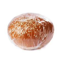 Fresh bun with plastic food wrap isolated on white