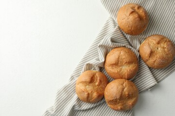 Homemade tasty buns on white table, top view. Space for text