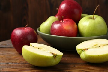 Fresh red and green apples on wooden table
