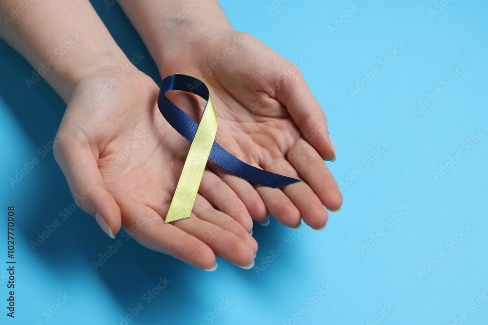 Sticker Woman with colorful ribbon on light blue background, closeup. Down syndrome awareness