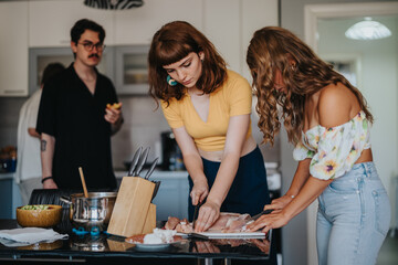 A group of friends preparing a meal together in a stylish kitchen. They are engaged in chopping ingredients and enjoying each other's company.