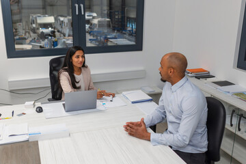 Job interview in an office, an Indian female manager discussing with a motivated African American...