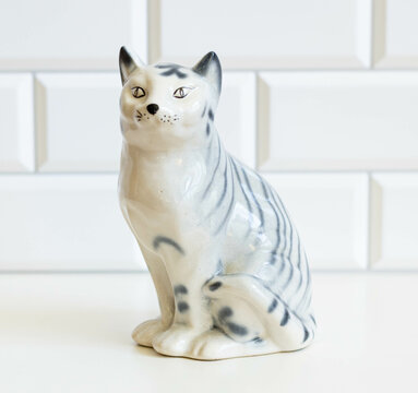 Life-Like Ceramic Cat Statue &ndash; Realistic Animal Figurine Isolated with White Tiled Background