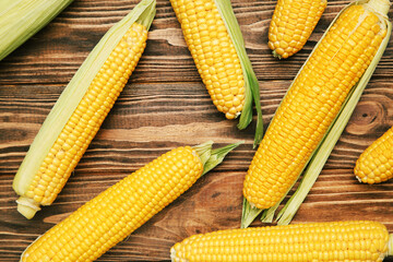 Ripe corn on brown wooden table