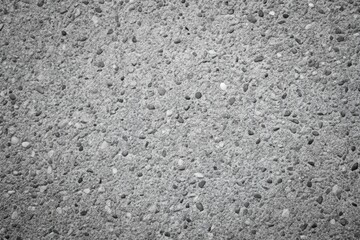 Exposed aggregate concrete texture in black and white minimalist style