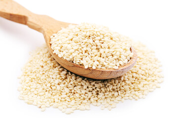 Sesame seeds in wooden spoon isolated on white background