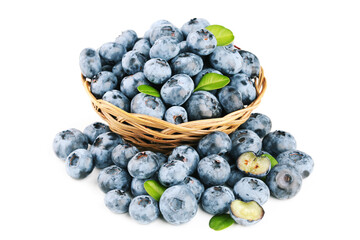 Blueberries with green leafs in basket isolated on white background