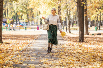 Fototapeta premium Autumn portrait of a young beautiful blonde woman