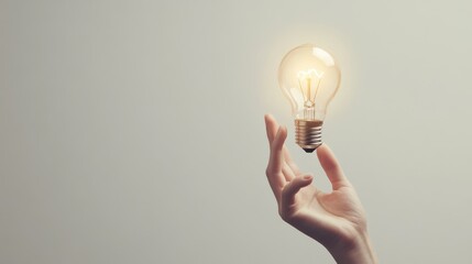 Hand holding a glowing lightbulb, symbolizing a bright idea, against a clean white background, ample space for text
