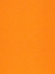 background for Halloween: close up striped orange cardboard texture