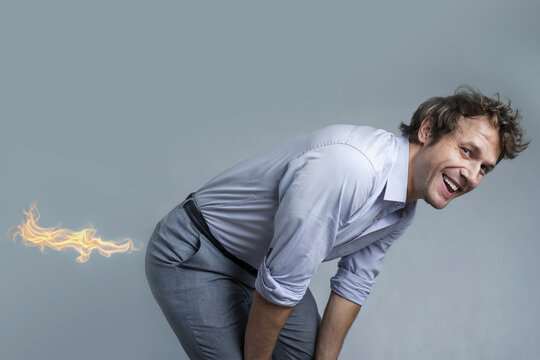 Male businessman with flames coming out of his butt.
