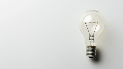 Lightbulb with a subtle illumination on a white background, large area for text placement
