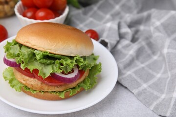 Delicious vegetarian burger with chickpea cutlet on light table, closeup. Space for text