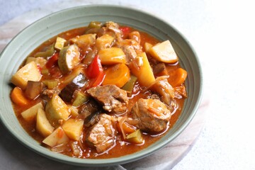 Delicious stew with vegetables in bowl on table, closeup