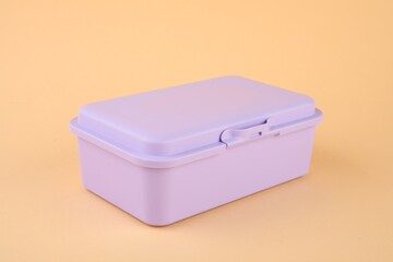One plastic lunch box on peach background