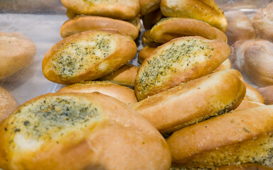 Buns with cheese and dill on the counter in the store. Bakery products on sale